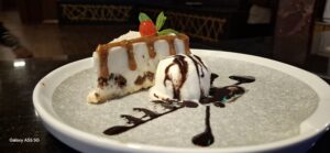 Moist cake slice served at a top-rated bakery in Kigali, showcasing layers of cream and sponge.