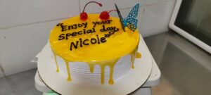 Freshly baked birthday cake in Kigali Rwanda, topped with vanilla buttercream and sprinkles for celebrations.