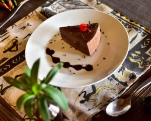 Cake slice on a ceramic plate, handmade in a Kigali bakery known for its creative confections.