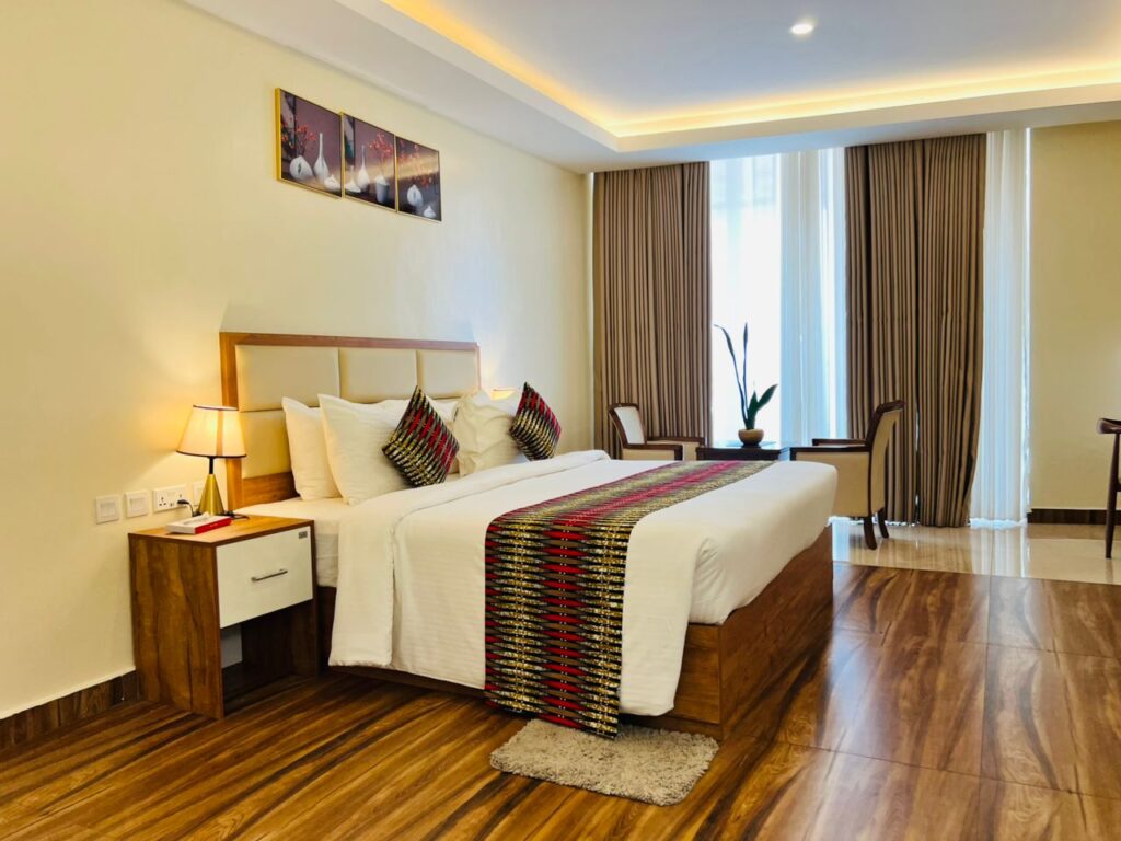 Comfortable seating area within a deluxe room at The Hut Hotel, perfect for relaxing after events at Kigali Convention Center.