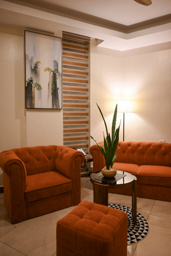 Luxury Junior Suite at The Hut Hotel Kigali featuring a queen bed and private balcony views.