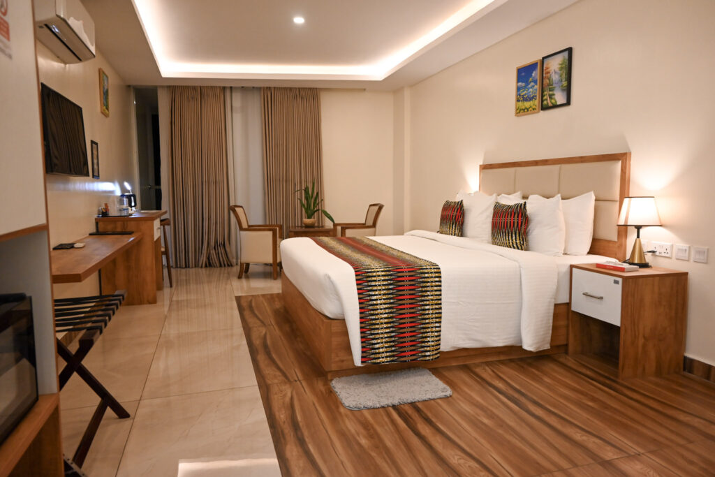 Cozy Standard Room at The Hut Hotel with modern décor, comfortable queen bed, and relaxing city-stay atmosphere