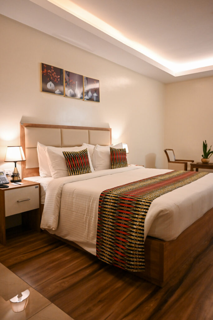 Spacious Premier Room at The Hut Hotel featuring a king bed and comfortable seating area